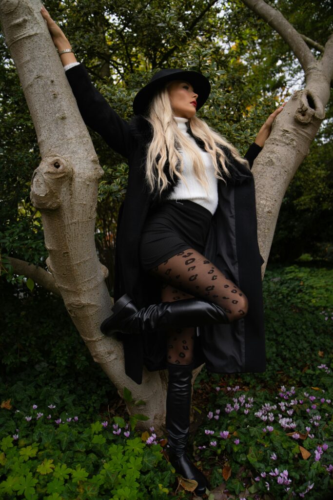 black hat, skirt, boots, tree